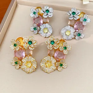 Detail view of luxury vintage floral earrings with colorful zircons and pink oval stone