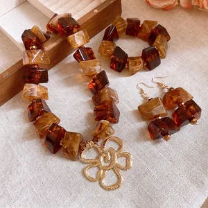 Vintage Maillard amber acrylic necklace bracelet and earring set with gold flower charm