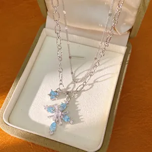Double-layered silver chain necklace with blue zircon cross pendant in a gift box