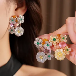 Close-up detail of vintage flower stud earrings with zircons and colorful gemstones