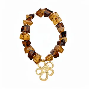 Elegant retro Maillard style necklace with amber acrylic beads and a gold flower pendant.