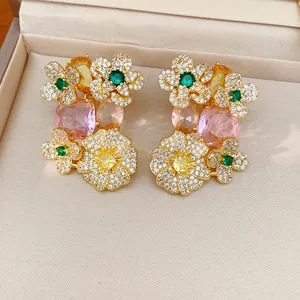 Detailed macro shot of vintage gold flower stud earrings with colorful paved zircon stones
