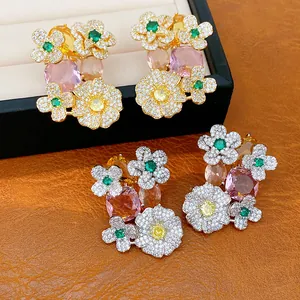 Close-up of vintage flower earrings with colorful zircons in gold and silver tones