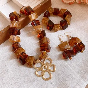 Vintage Maillard acrylic jewelry set with flower pendant necklace, bracelet, and earrings.