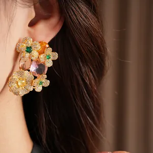 Macro detail of vintage-style floral earrings featuring sparkling colorful zircon stones.