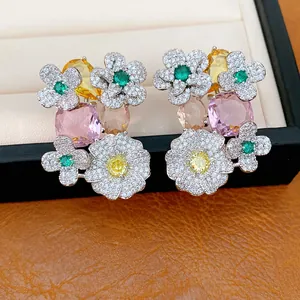 Close-up of floral zircon earrings with colorful pink, yellow, and green stones