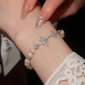 Close-up of elegant star pearl bracelet with zircon on woman's wrist detail view