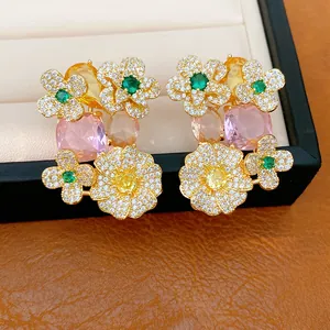 Detail view of vintage-style flower earrings featuring colorful zircons and gold-tone finish