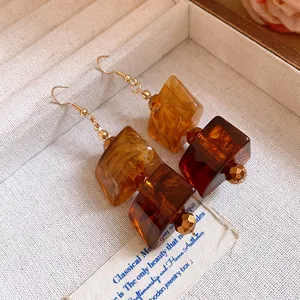 Detailed close-up of Maillard style vintage acrylic drop earrings with geometric beads