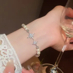 Elegant 18K gold plated pearl bracelet featuring sparkling zircon star charms detail.
