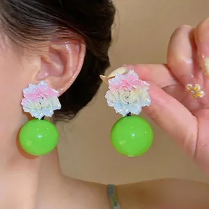 Exaggerated resin floral stud earrings with large green spherical drops for women
