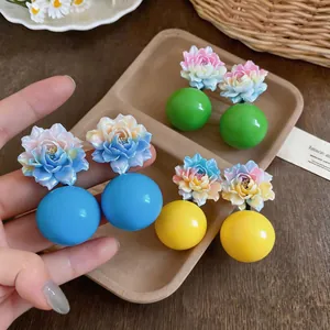Detailed view of colorful resin flower earrings with vibrant round bead drops