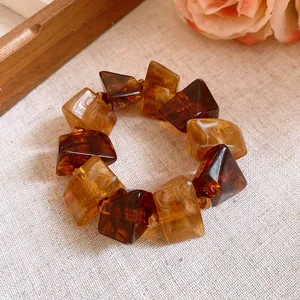 Detail of vintage Maillard style acrylic bracelet with amber tortoiseshell beads.
