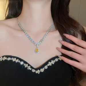 Elegant luxury yellow water-drop zircon necklace worn by a model in a black floral dress