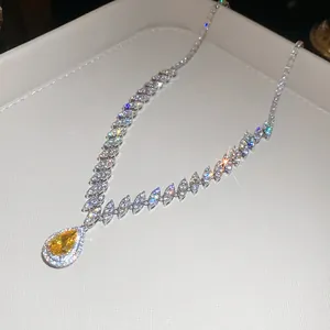 Detailed macro view of teardrop yellow zircon necklace with sparkling marquise-cut stones