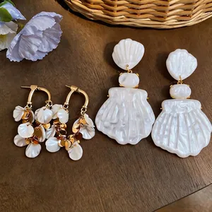 French vintage style shell and gold petal tassel earrings for a luxury vacation look