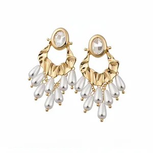 Vintage gold-tone drop earrings featuring oval rhinestones and white pearl tassels
