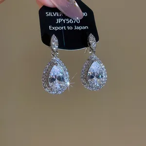 Detail showing luxurious silver-plated teardrop zircon earrings with brilliant sparkles