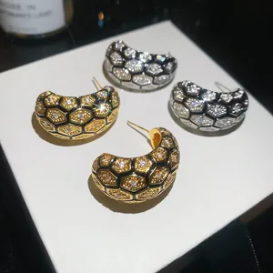 Detailed view of vintage 18k gold plated honeycomb earrings with sparkling zircon inlay