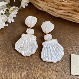 Detailed view of French vintage shell earrings with an elegant pearlescent finish