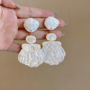 Detailed shot of vintage French style shell earrings with mother of pearl finish