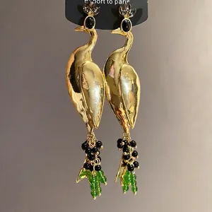 Vintage oversized golden peacock drop earrings with luxurious green and black bead fringe