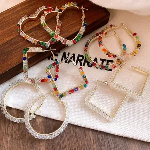 Detailed view of colorful glass bead hoop earrings in heart, square, and round shapes