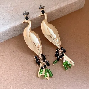 Elegant gold peacock pendant earrings with black and green bead tassels for women.