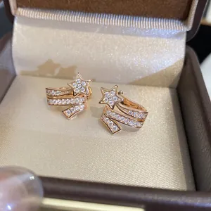 Sparkling zircon star-shaped shooting star ear clips in a jewelry box