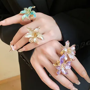 Detailed close-up view of vintage colorful enamel flower open rings on fingers