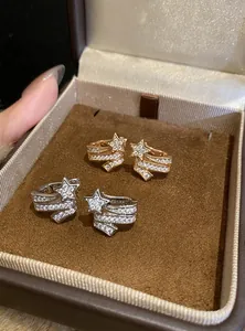 Detailed view of sparkling zircon star ear clips in elegant gold and silver finishes