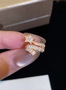 Close-up of a sparkling zircon star shooting star ear cuff in gold finish
