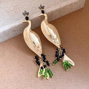 Macro view showing the intricate gold peacock design and colorful bead tassels
