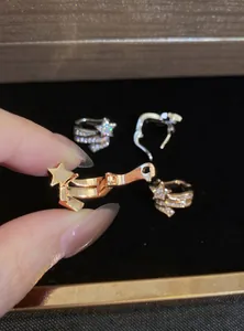 Close-up detail of rose gold star ear cuff with sparkling zircon showing hinge mechanism