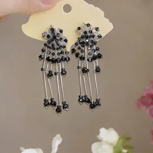 Exquisite flower tassel dangle earrings featuring black crystals and silver finish.