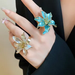 Detailed macro view of vintage enamel tulip flower rings in blue and white colors