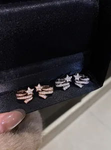 Detail view of sparkling zircon star ear bone clips in rose gold and silver finish
