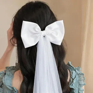 Elegant white fabric bow hair clip featuring a long and delicate mesh veil tassel detail