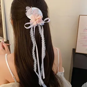 Elegante stoffen bloem en strass vlinder haarclip met lange kanten kwastjes