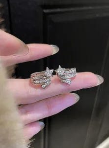 Detail view of sparkling silver star ear clips with white cubic zirconia accents