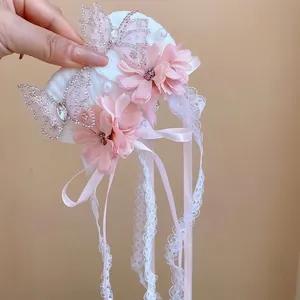 Roze bloem haarclip met strass vlinders en lange kant kwastjes