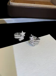 Close-up of elegant silver star ear clips with sparkling zircon for non-pierced ears.