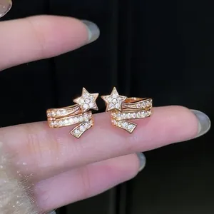 Macro detail of rose gold star ear cuffs featuring sparkling clear pavé-set zircons