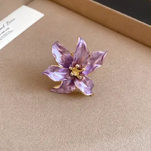 Detail view of a vintage-style purple enamel tulip flower ring with gold edges.