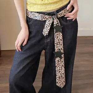 Detailed view of long leopard print silk scarf featuring black leather star accents