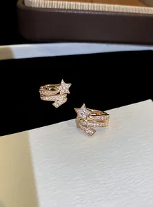 Detail view of sparkling zircon star ear cuff jewelry in elegant rose gold finish.