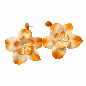 Orange and white gradient fabric flower drop earrings with raffia accents for beach vacations.