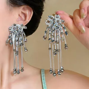 Detailed macro view of exquisite silver beaded tassel earrings with floral design