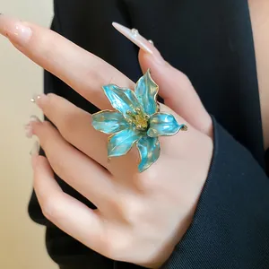 Close-up of vintage turquoise tulip flower ring with elegant golden petal edges.
