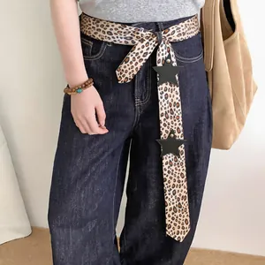 Leopard print faux silk scarf with leather star patchwork used as a waist belt accessory